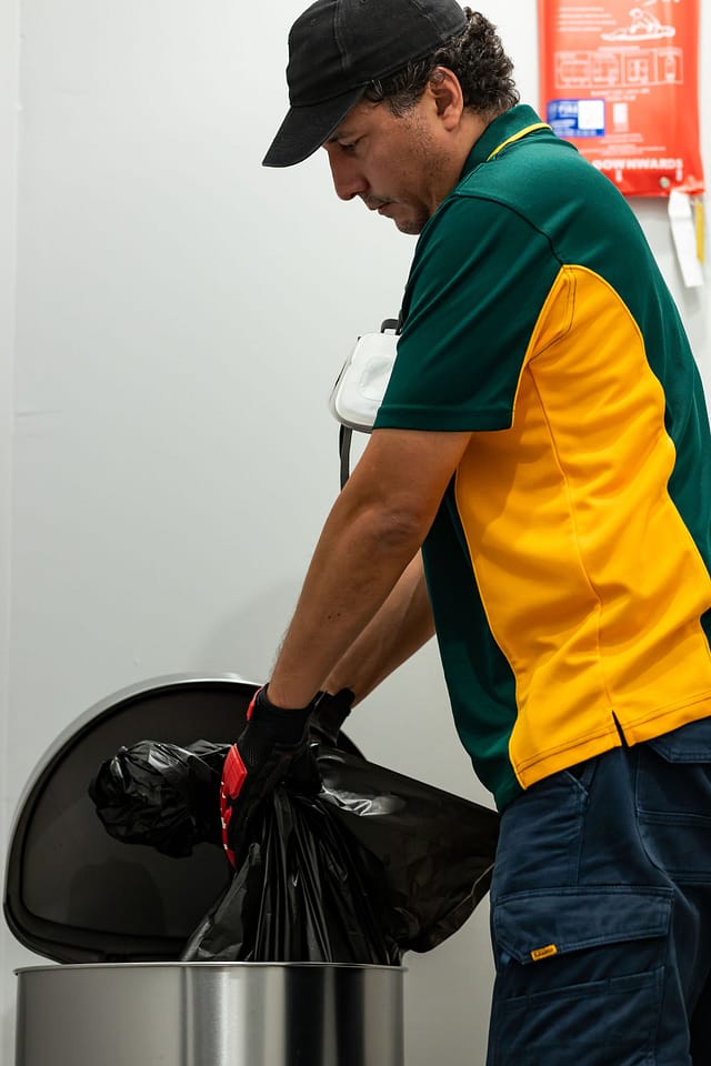 hygiene service technician emptying sanitary bin
